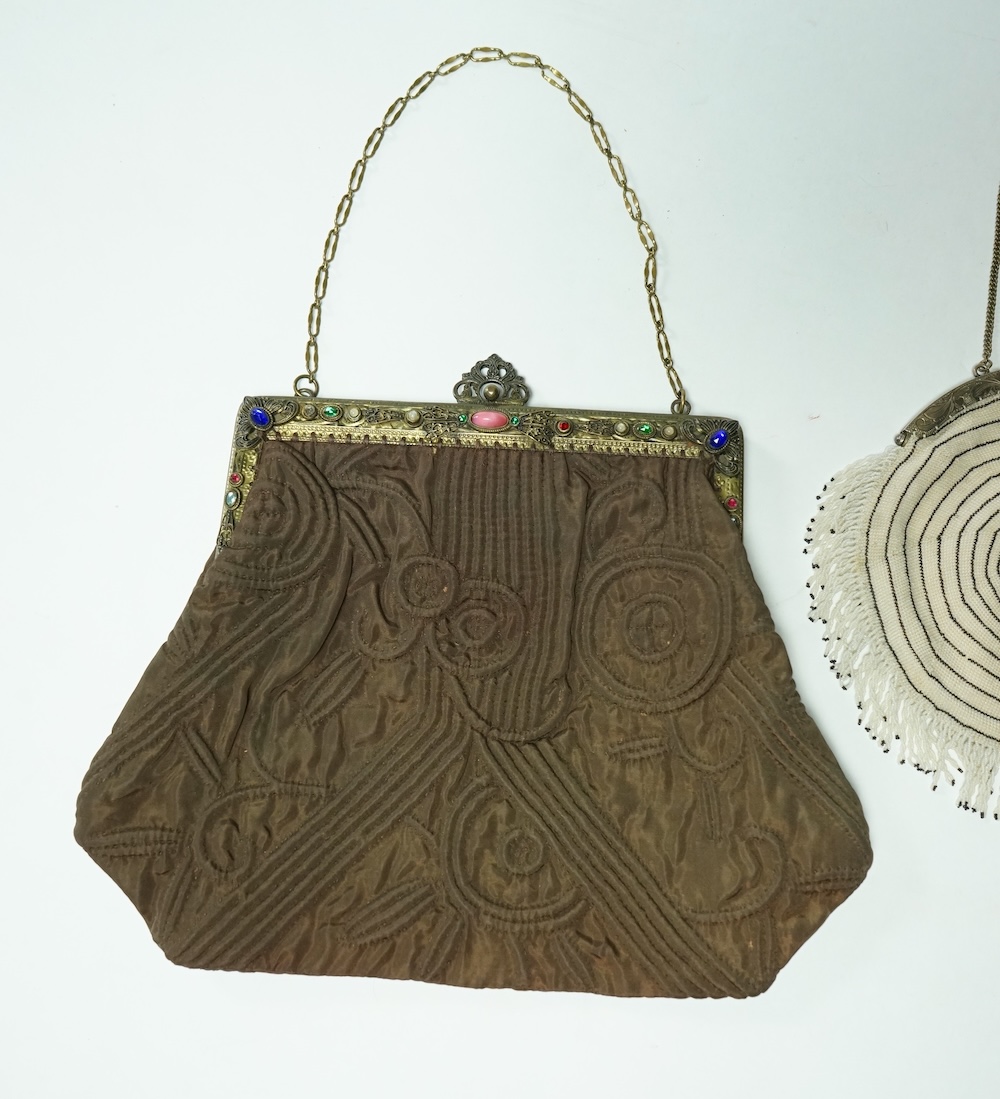 A 1930’s black and white finely beaded evening bag with a German 830 standard stamped metal frame together with a marcasite framed black satin bag and a brown quilted bag with an ornate paste set gilt frame. Largest 21.5